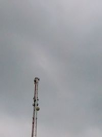 Low angle view of communications tower against sky