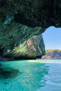 Scenic view of sea by rock formation