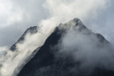 Low angle view of volcanic mountain against sky