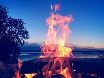 Bonfire against sky at sunset
