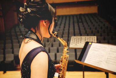 Midsection of woman playing piano