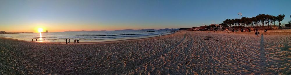 Scenic view of beach against sky during sunset