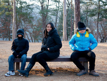 Portrait of friends sitting on land