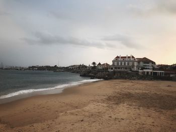 Building on beach against sky in city