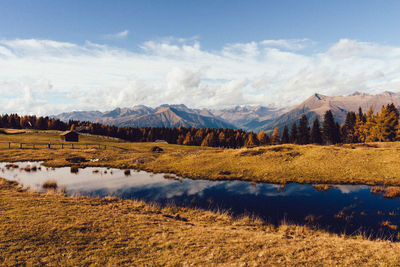 Scenic view of lake and mountains against sky