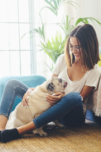 Girl with dogs sitting at home