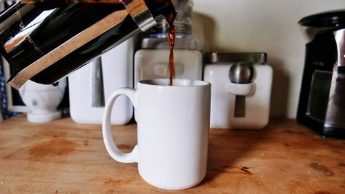 Close-up of coffee cup on table at home