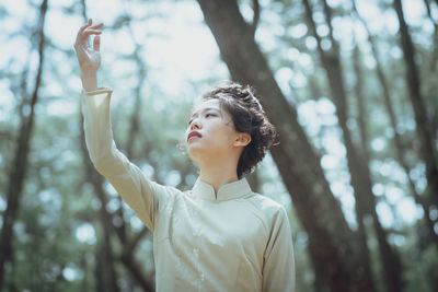 Young woman looking at camera in forest