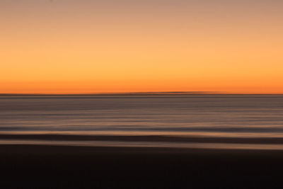 Scenic view of sea against romantic sky at sunset