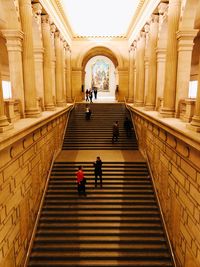 People walking on staircase in building