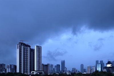 Modern buildings against blue sky at dusk