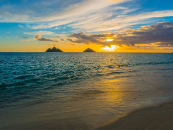 Scenic view of sea against sky at sunset