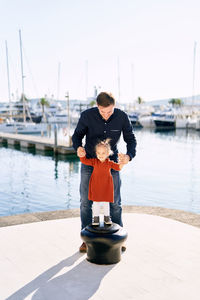 Full length of man standing in sea against sky