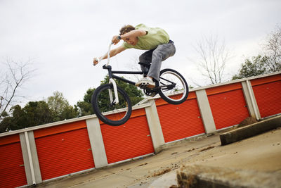 Man performing stunt against clear sky