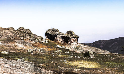 Rock formation on mountain against sky