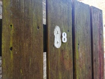 Close-up of text on wooden door