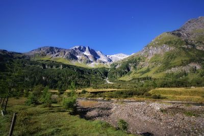 Scenic view of mountains against clear blue sky