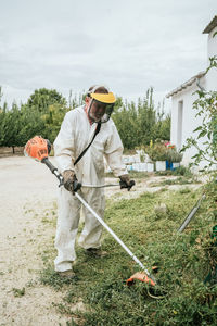 Rear view of man working on field