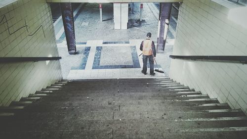 Full length of woman walking on sidewalk