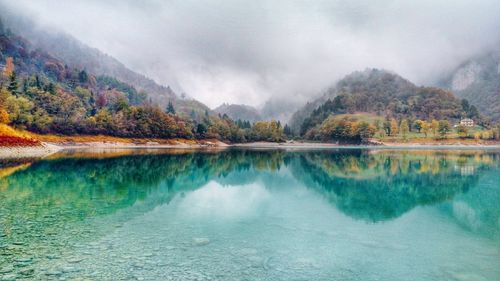 Scenic view of lake and mountains against sky