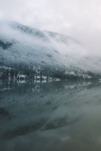 Scenic view of frozen lake against sky during winter