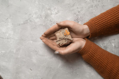 Cropped hands of woman holding gift box