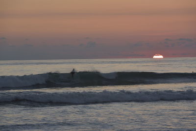 Scenic view of sea at sunset