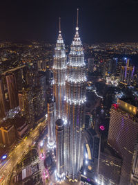 High angle view of city lit up at night