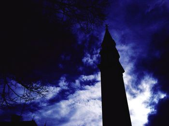 Low angle view of building against cloudy sky