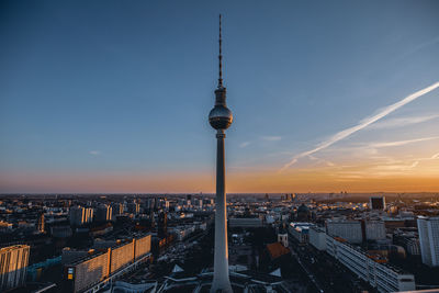 High angle view of city buildings against sky during sunset