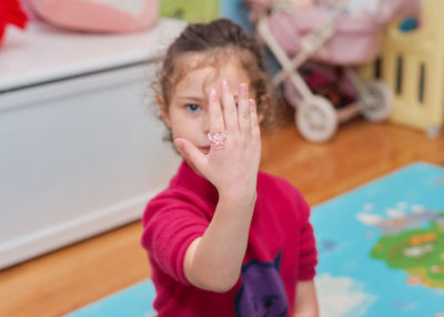 Pretty young girl playing with her beauty accessories