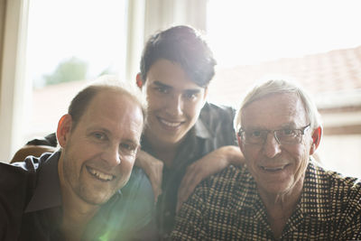 Portrait of three generation family smiling together at home