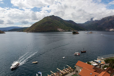  roofs of old houses in perast and bay with mountains in montenegro