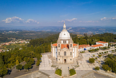 Panoramic view of buildings and trees against sky