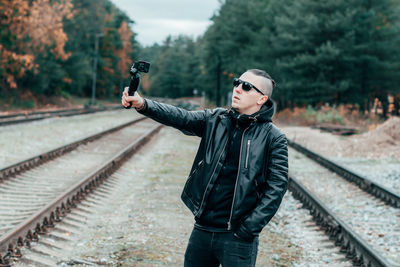 Full length of man standing on railroad track
