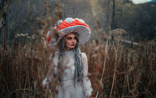 Portrait of woman standing in forest