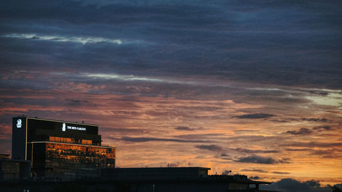 Low angle view of building against dramatic sky