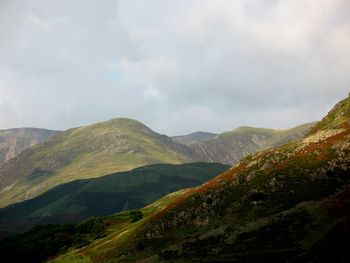 Scenic view of mountains against cloudy sky