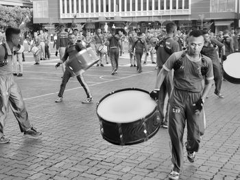 Group of people playing on street in city