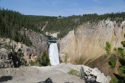 Scenic view of waterfall against sky