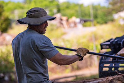 Side view of man working with tools