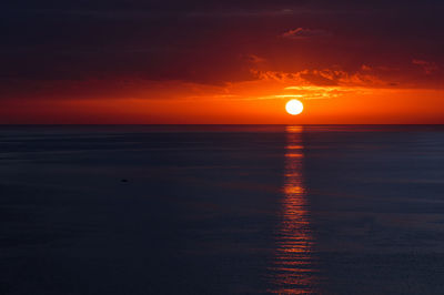 Scenic view of sea against romantic sky at sunset