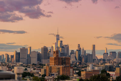 View of cityscape against cloudy sky