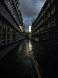 Road amidst buildings in city against sky