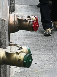 Low section of man working on metal in city