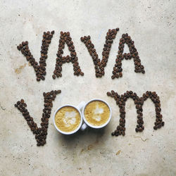 Directly above shot of coffee  bean word art text on stone table 