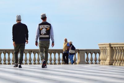 People in front of monument against clear sky