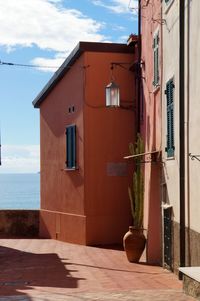 Exterior of building by sea against sky