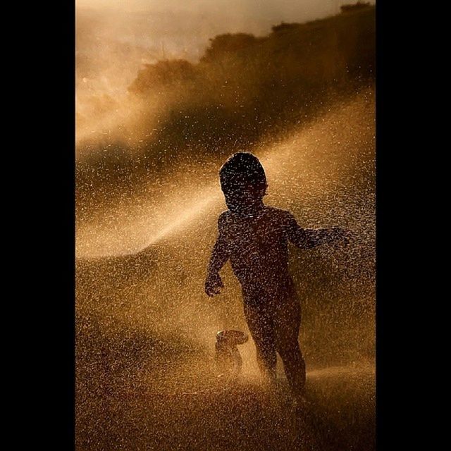 lifestyles, silhouette, water, leisure activity, full length, men, auto post production filter, transfer print, reflection, standing, indoors, window, wet, boys, rear view, glass - material, weather, transparent