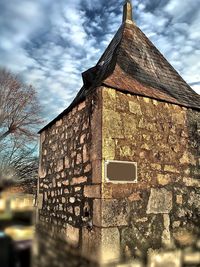 Low angle view of built structure against cloudy sky